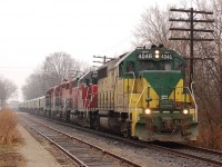 GEXR X432 rolls through residential downtown Guelph with an export train of locomotives destined for Britian. On this grey, foggy and wet day in charge of the train were GEXR GP40-2 4046-GEXR GP40 4019 - RLK GP35 2210- RLK GP40 4096.