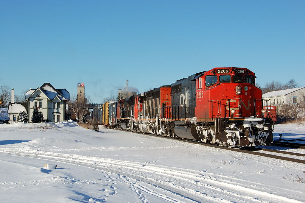 A pair of vetern SD40-2W\'s and new SD70M-2 lead this eastbound freight past the passenger station in Woodstock, Ontario. CN 5266-CN 5348-CN 8019.