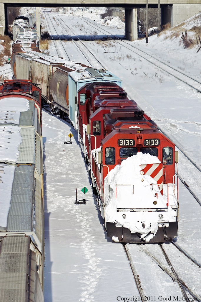 After yet another short delay T07 regains the track at Agincourt with a large mass of snow from drifts in the Whitby area.
