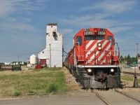 CP 3099 waiting on the conductor to tie up a joint as the old Wheat Pool towers over them.