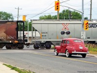 A shiny classic car waits as T07 departs Havelock.