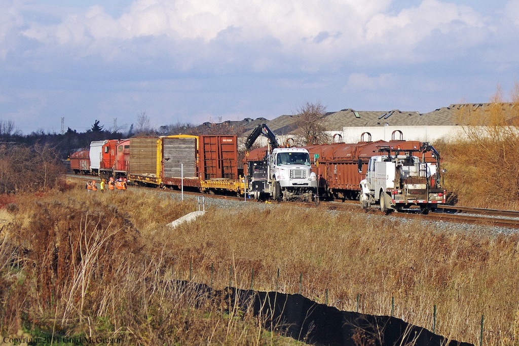 After switching an Industry on Tapscott road a derailment occurred on the Havelock Sub with both siding and track blocked it left T07 stranded at Passmore Ave.A Hi-rail truck was attempting to raise the cars as CP staff looks on.