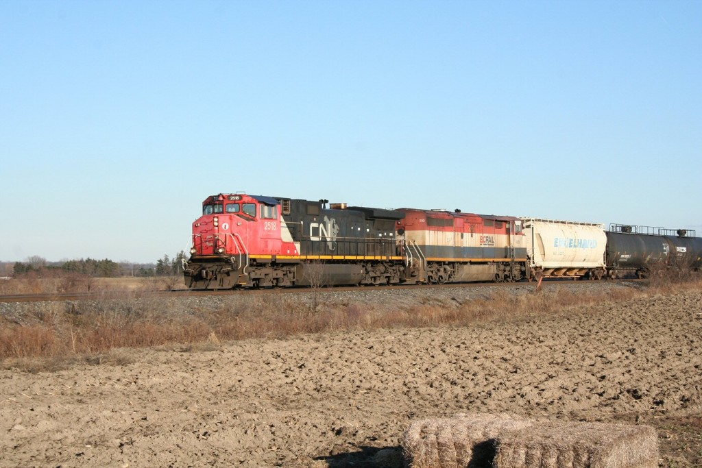 CN 331 with a C44-9CW from CN\'s first order, with the unique Canadian-style safety cab, and a full-carbody BC Rail C40-8CM approaches its destination at Sarnia on Boxing Day, 2011.