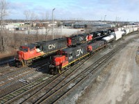 With a yard job busy sorting cars on an adjacent track, CN 385 heads out of Sarnia yard with a pair of new NS SD70ACe locomotives trailing the power.