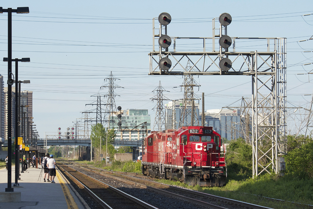 CP 8212 and STLH 8225 sink into the grass as they stroll down the South Service to lift 68 axles worth of train for Toronto Obico.