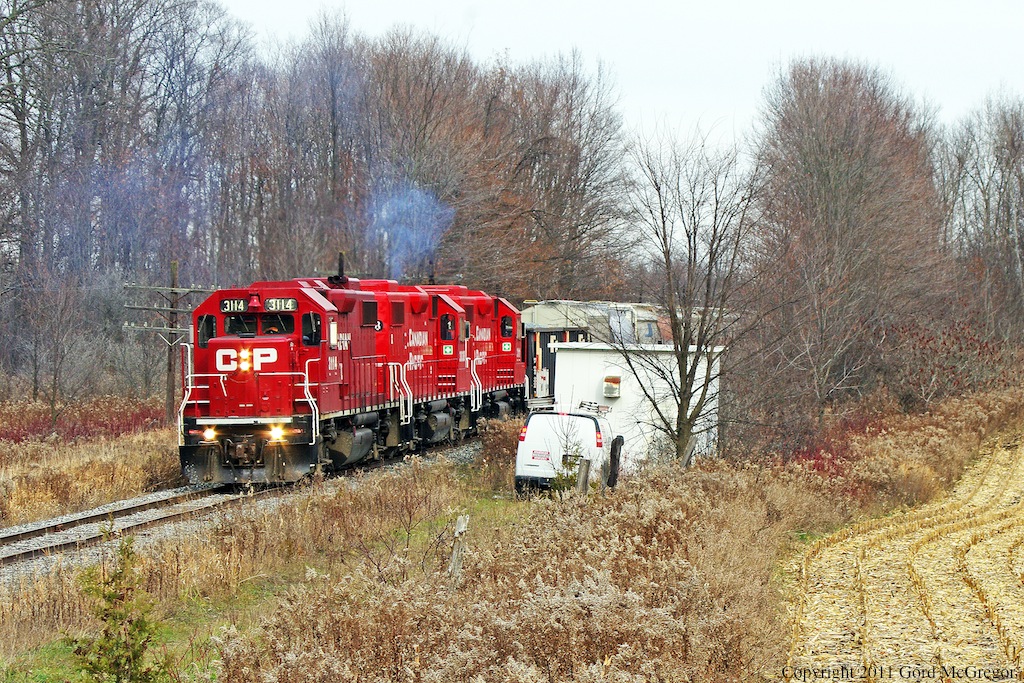 Struggling with 2 ballast hoppers 3114 lets some throttle and meeting with a service van in the wilds of Pickering.