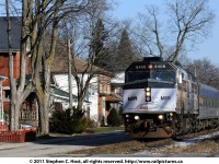 Would you live on this street? Train #85 with VIA Rail 6408, painted in Coors Light livery is heading alongside the "street running" of Guelph. You can see the homes and porches along the north side of Kent. St, and the south side of Kent is to the right of the picture, also with homes facing the street and railway. Kent St. is very close to downtown Guelph and pre-dates the arrival of the Toronto and Guelph/Grand Trunk Railway in 1855.