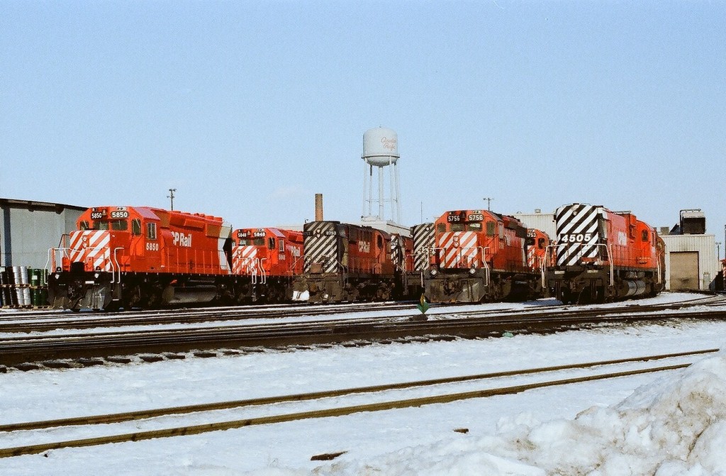 The Stripes! CP Rail Agincourt on a Sunday morning December 1978. Brand new 5850-5848-along side 8753-8768-42xx-5756-5753-4505; Model mix: SD40-2, MLW RS-18, a partially hidden C424 and a MLW M630. And ten plus years into the Multi-Mark Era the water tower remains CPR Script! Kodak Kodacolor II negative by S. Danko.