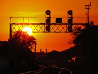 I've always been a stickler for sunrise/sunsets and this one is no different, the sun begins to set in the red western sky behind the signals that guard westward train movements onto the Galt Sub from the North Toronto Sub. 