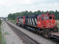 CN 306 with 5082 rolls slowly to a stop as the 207 with 2111 appears out of the curve.