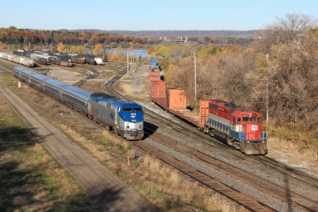 VIA 97 rolls through the SOR Yard on the Hamilton Waterfront on the hot track while SOR 4057 drops a pair of bulkhead flatcars on the pocket track.