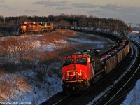 No race here as CN 305, behind CN 2295 and DPU 8004, handily whips past CP 643 at Lovekin. 643, behind CP 5995, CITX 2790, ICE 6404, and ICE 6456 is slowly pulling through the siding as CP 130 (out of view with CP 5746, CITX 2797, and CP 5923) holds the main. Eight minutes earlier, CN 372 has roared past; four freights in under ten minutes. A long day of foaming and driving began at Lovekin in the morning as I chased a pair of SD9043MAC's on 3rd 234 as far east as Roblindale. Yes, they are that rare on the Belleville Sub. However, I quickly lost interest in the SD90's as 643's colourful lash-up exited Roblindale siding after meeting 3rd 234. One more shot of 643 in the glow of dusk at Bowmanville topped off what was a pretty good day. 1659hrs.