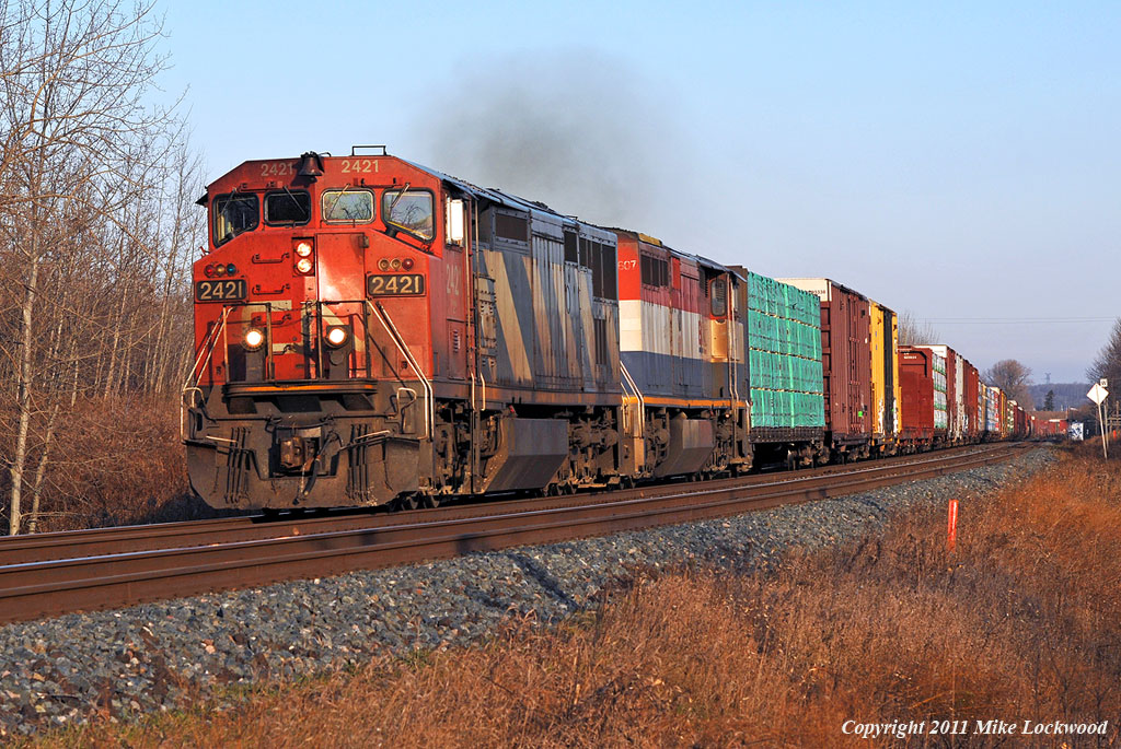 CN train 369 is at the west end of the new alignment, built circa 1912, through Newtonville behind CN 2421 and BCOL 4607. 1513hrs.