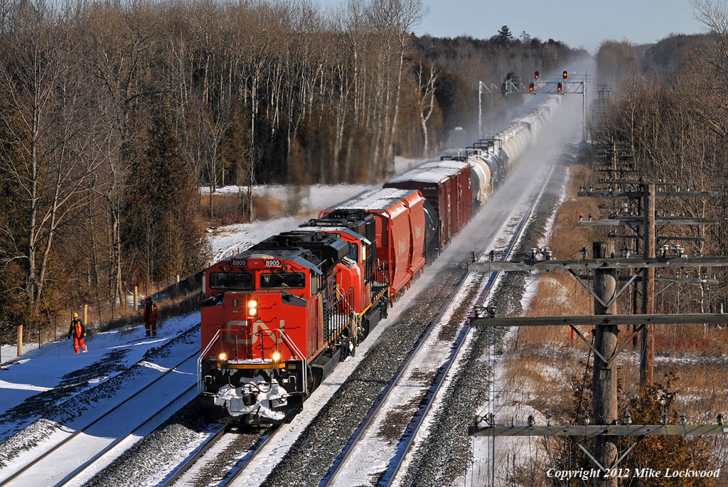 CN 373 flies past the maintainers working on the new third track west of Grafton behind 8905, 5745 and mid train DPU 2665. 1244hrs.