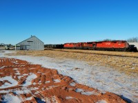 An eastbound CP arrives in Wynyard on the first day of 2012 with a pair of red barns sandwhiching a mac. 