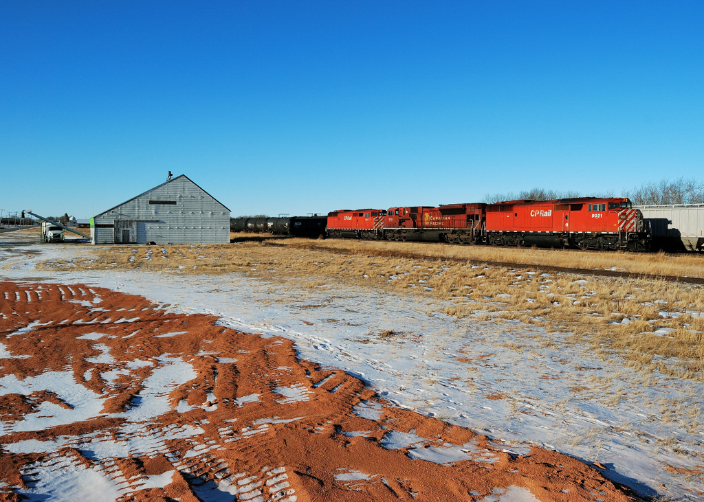 An eastbound CP arrives in Wynyard on the first day of 2012 with a pair of red barns sandwhiching a mac.