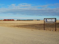 Trying to make it home in time for Christmas a pair of 90 macs hustle westbound past the sign to Big Quill resoucres on the shore of Big Quill Lake. 