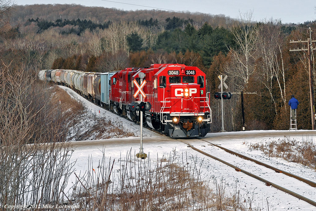 CP 3048, 3032, and 3111 pass by Balsam as Gord gets off his perch. Have ladder, will railfan. 0932hrs.