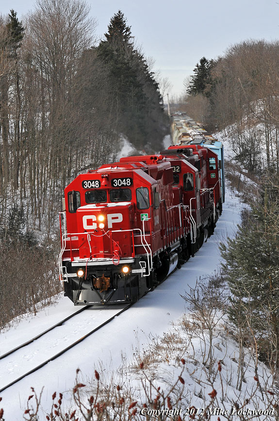Freshly shopped CP 3048 is out front on T08, trailed by 3032, 3111 and the 16 cars of T08 as they roll through a winter wonderland east of Raglan. 1008hrs.