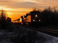 The setting sun glints off the side of CP 8726 and 9656 as they take train 232 east. 1704hrs.