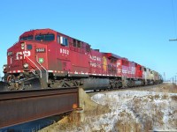 CP 627 led by CP 9802, SOOs 6051 and 6027, heads westbound around the bend in Tilbury on its way towards Windsor.