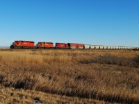 A trio of SD40-2's make their way west towards Saskatoon. Off in the distance behind the lead unit is the massive Big Quill salt water lake. 