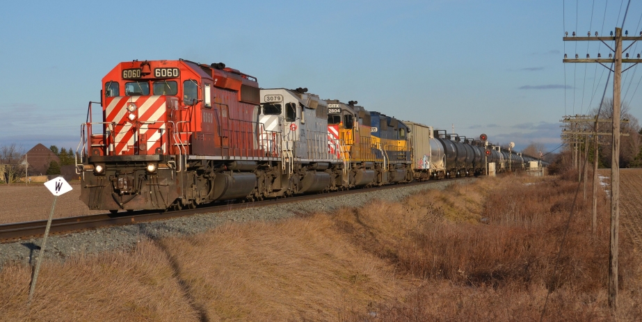 CP 627 leaving Lobo siding with colourful EMD lashup CP 6060, CItx 3079, Citx 2804 & ICE 6415