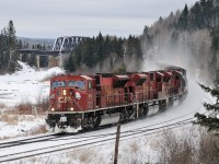 A trio of SD90Mac's power the westbound "paper train" (421-04)  alongside the Matawin River west of the subdivisions namesake location, Kaministiquia. Power: 9109-9141-9120.