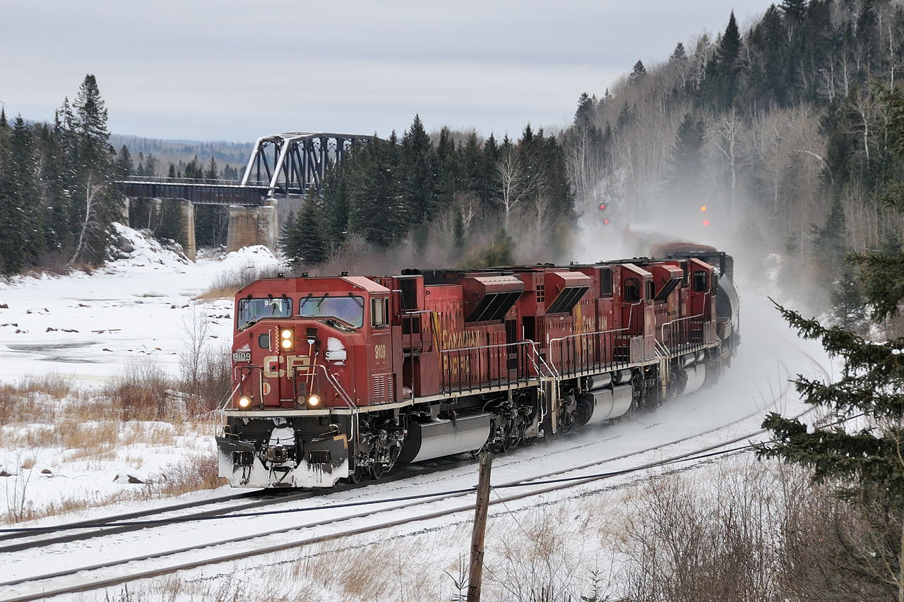 A trio of SD90Mac\'s power the westbound \"paper train\" (421-04)  alongside the Matawin River west of the subdivisions namesake location, Kaministiquia. Power: 9109-9141-9120.