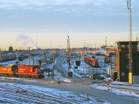 A frosty start to the day at Agincourt Yard a set of yard power sits along with a row of scrap units that have been sitting since May 2011.Beside the tower a unit is taking 3048 to replace 3114 on The Havelock Consist.