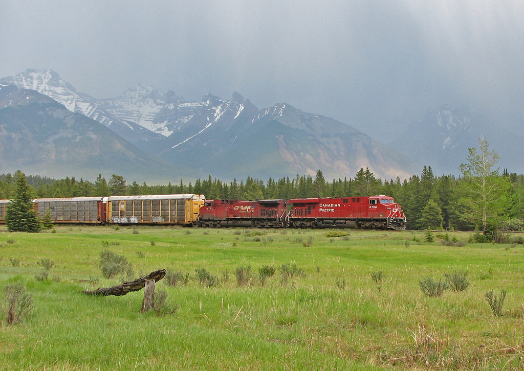An afternoon thunderstorm gives us some rain on our railfan trip into the mountains. CP 8759 is approaching the Banff station.