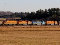 The rats are almost at the bar... A mixed sack of locomotives (HCRY, QGRY, DESX) click and clack at mile 150 of the Webbwood Sub with empty log & steel cars, and a few gons of scrap metal.