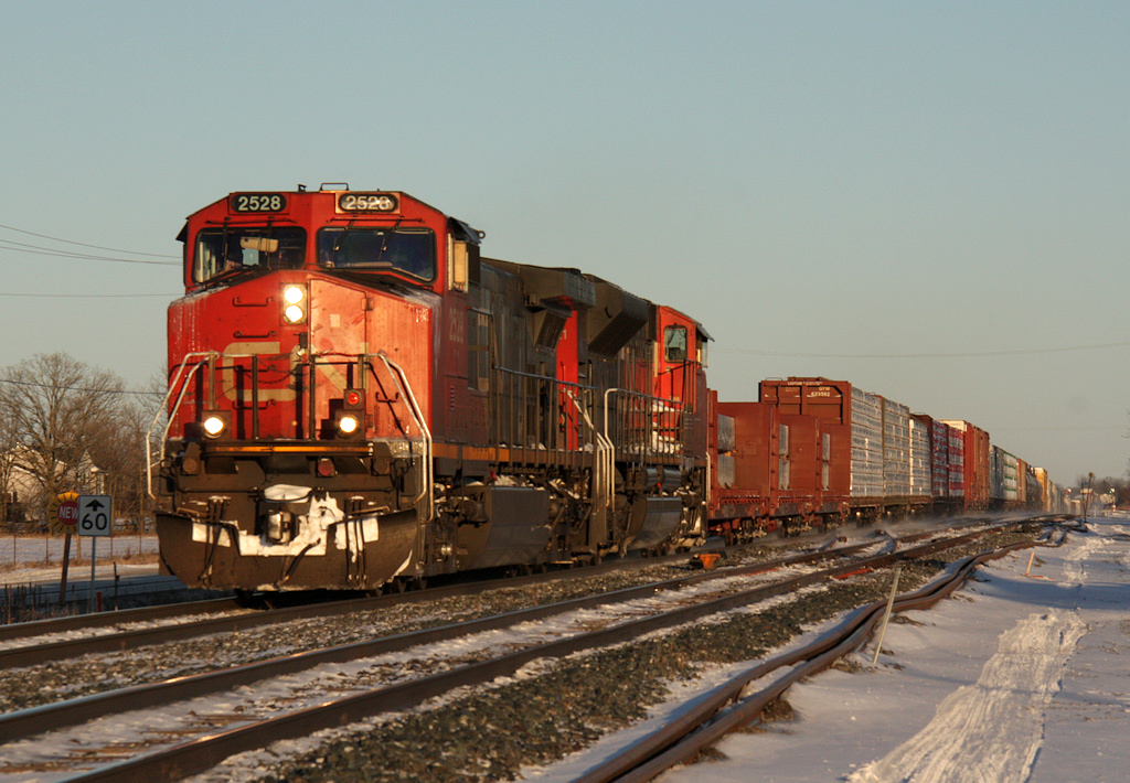 Train M36921 14 approaches Belleville with a long and heavy train of forest products and this and that