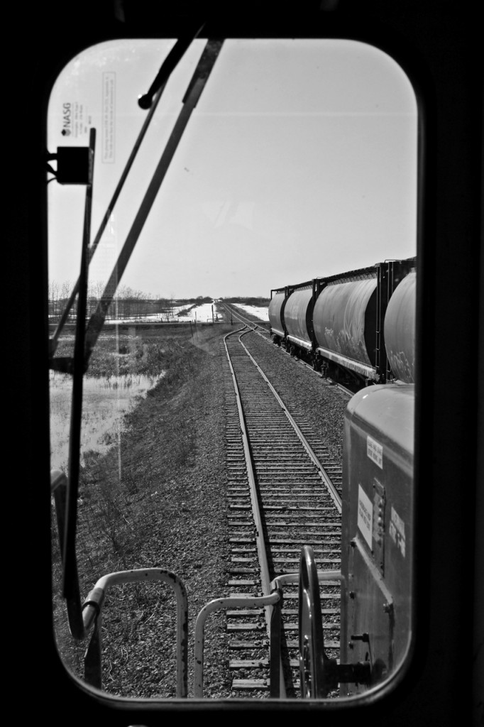 In the cab of CP GP38-2 3070 as we pull out of the elevator tracks lite and will tie onto the second string of empties and shove them into the elevator tracks.