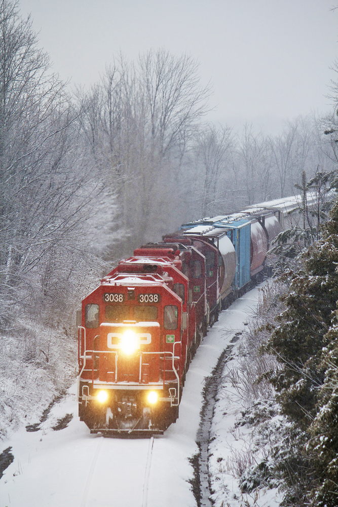 The Havelock Job meanders down the Kawartha Lakes Railway Havelock Subdivision with 3038 leading three other geeps and 32 cars for Toronto from Peterborough.