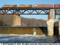 Here is Norfolk Southern train 327, Buffalo NY to St. Thomas, Ontario with two Foreign engines: UP 9788 and UP 9457. This yellow clad power pair leads the charge across the Grand River at Paris Ontario Canada, beside the ruins of an old water powered mill, in the waning days of the CN/NS \"Joint Section\" which, to this date had lasted 109 years and was scheduled to end at the turn of the new year..