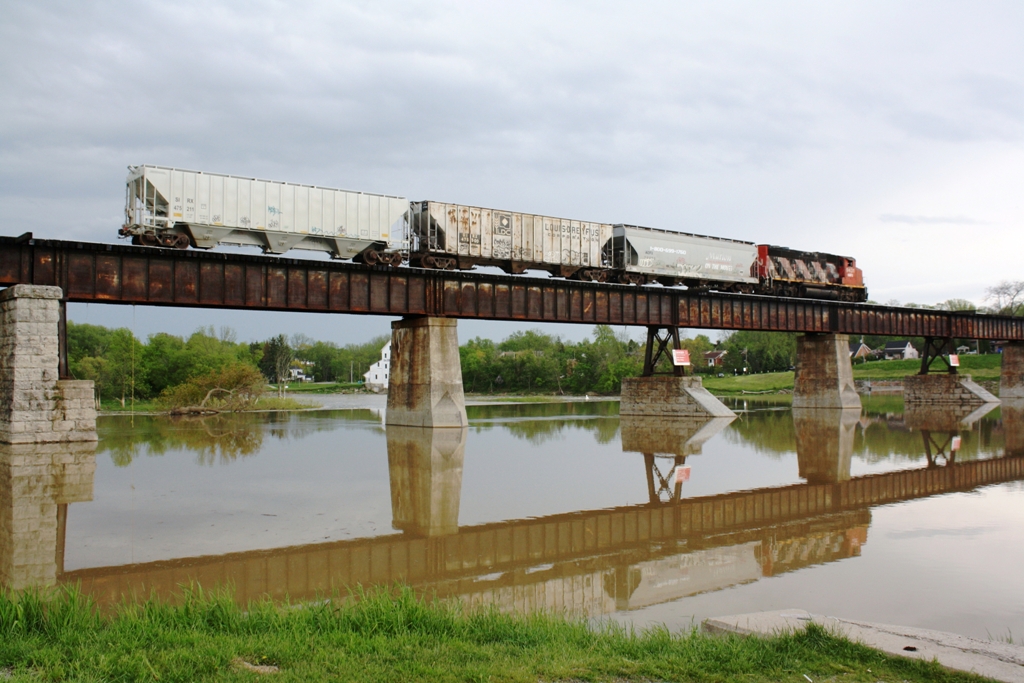 SOR 597 crosses the Caledonia bridge over the Grand River.  They have three cars in tow for Garnet yard to be taken to Brantford for the CN interchange.