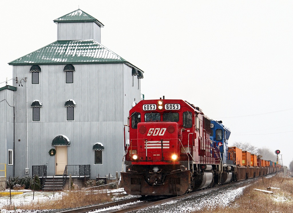 SOO 6053 with CEFX 3149 lead train 241 past the former grain elevator turned office tower at Elmstead Ontario, mile 101 on the CP\'s Windsor Sub.