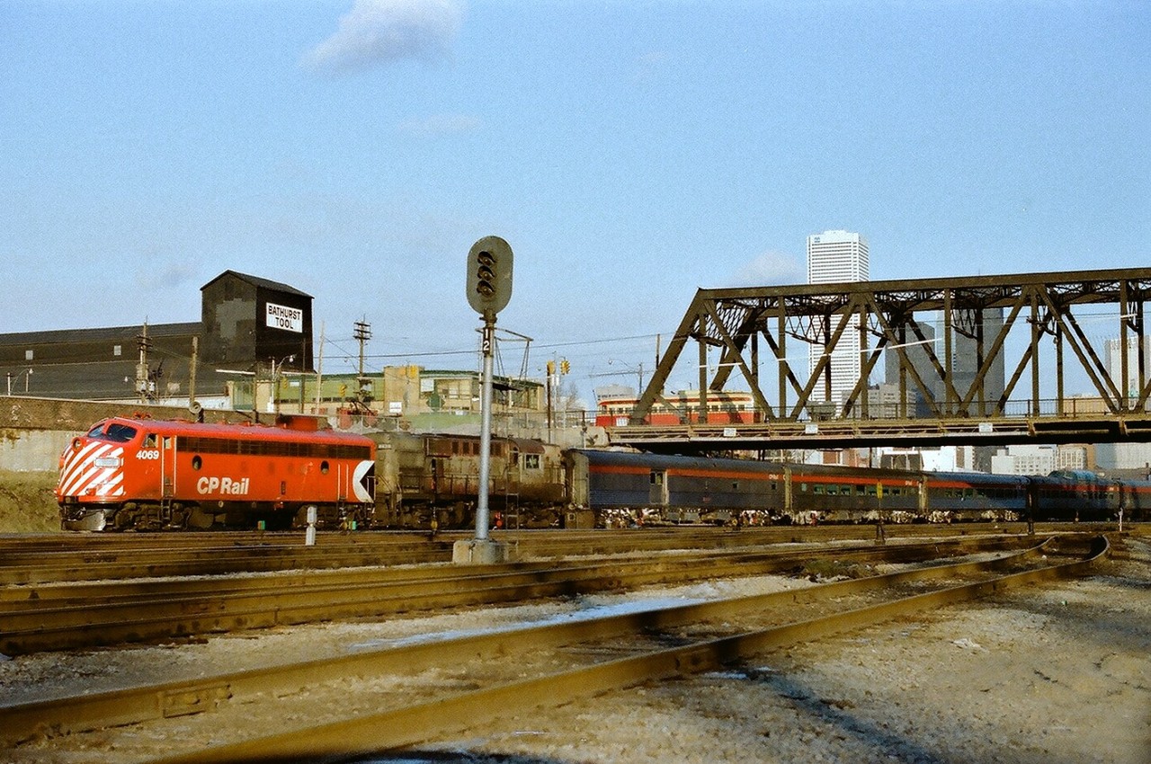 Happy New Year. 1978. On the first day of that year CP Rail train #11, the Toronto section of  The Canadian  , with FP7-A 4069 and RS-10 8478 , rolls under the Bathurst Street bridge complete with a PCC type streetcar at the Front Street intersection. Kodak Color II ASA100 colour negative. Photographer S. Danko.
