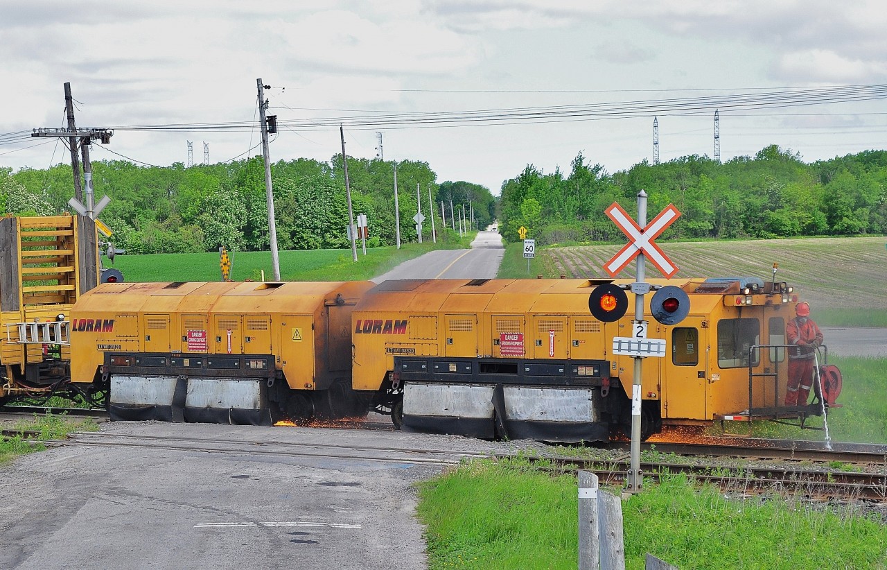 The Loram rail grinding train is busy - and dousing embers - at CP Lovekin. June 2 2011. Image by S.Danko