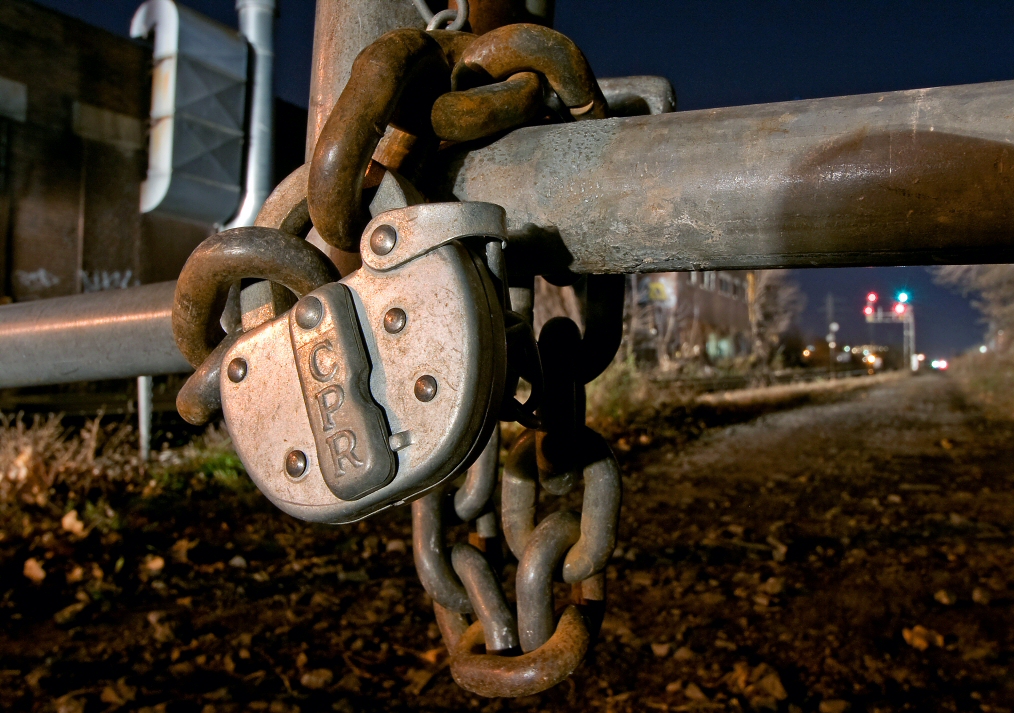 Showing the roots of company heritage, this switchlock stands guard as headlights of an oncoming expressway train light up the dark right of way.