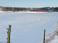 Rolling past the open fields and fresh snow near Burketon T08 with a matched consist and 5 grain cars on the head makes its passage.