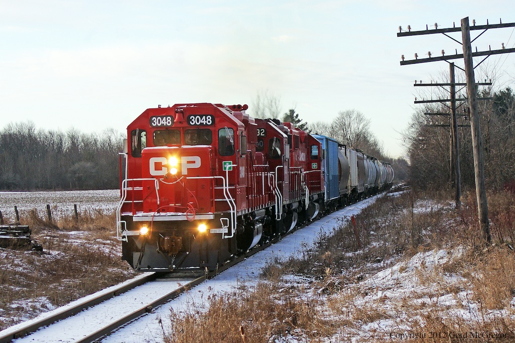 A shiny 3048 leads a short 16 car T08 through the Pickering countryside.