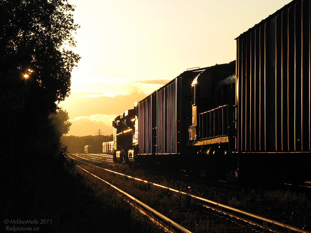 CEFX 1037 and CP 9818 lead train #254 out of CP\'s Lambton Yard and into the sunset, with a special treat in tow: Delaware Lackawanna RS3 4068. Originally built as D&H 4068, the RS3 later went on to a number of shortlines including the Lamoille Valley and York-Durham Heritage RR as their 7801. D-L purchased 7801 from YDHR to restore to operating condition to operate with their other 2 ex-D&H RS3\'s in freight service. The funny thing is, DL 4068 sat around CP\'s Agincourt Yard for a week before heading out on CP 254, only to be set off at Milton because of brake problems.