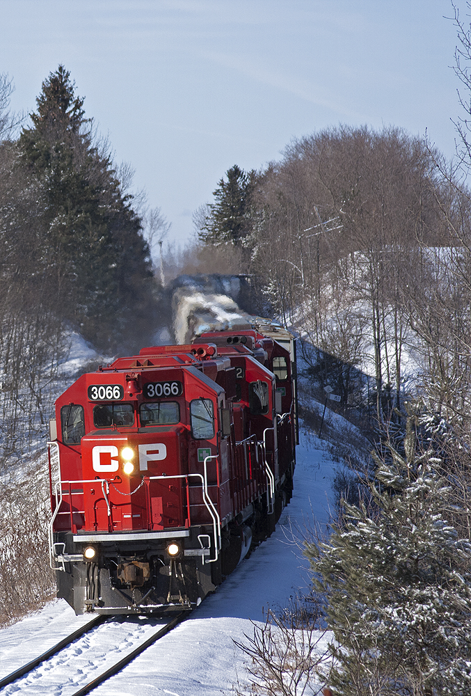 CP 3066 fresh out of the shop leads T08 as 3032, 3038 trail on this 25 or so car train, taking the curve. And thanks to fellow rp.ca contributior Mike Lockwood for the amzing chase up the Havelock Sub and showing a few of his secret spots along the line.