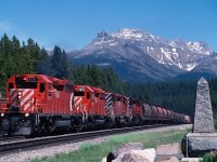 This eastbound is just about to leave BC at the Continental Divide. A friendly crew member is enjoying a nice summer day.