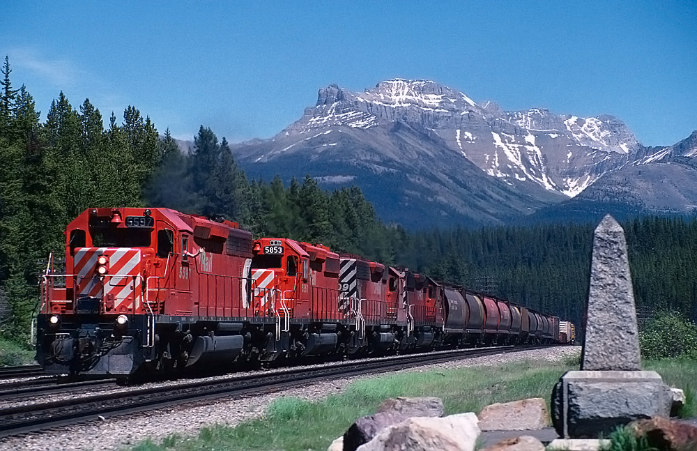 This eastbound is just about to leave BC at the Continental Divide. A friendly crew member is enjoying a nice summer day.