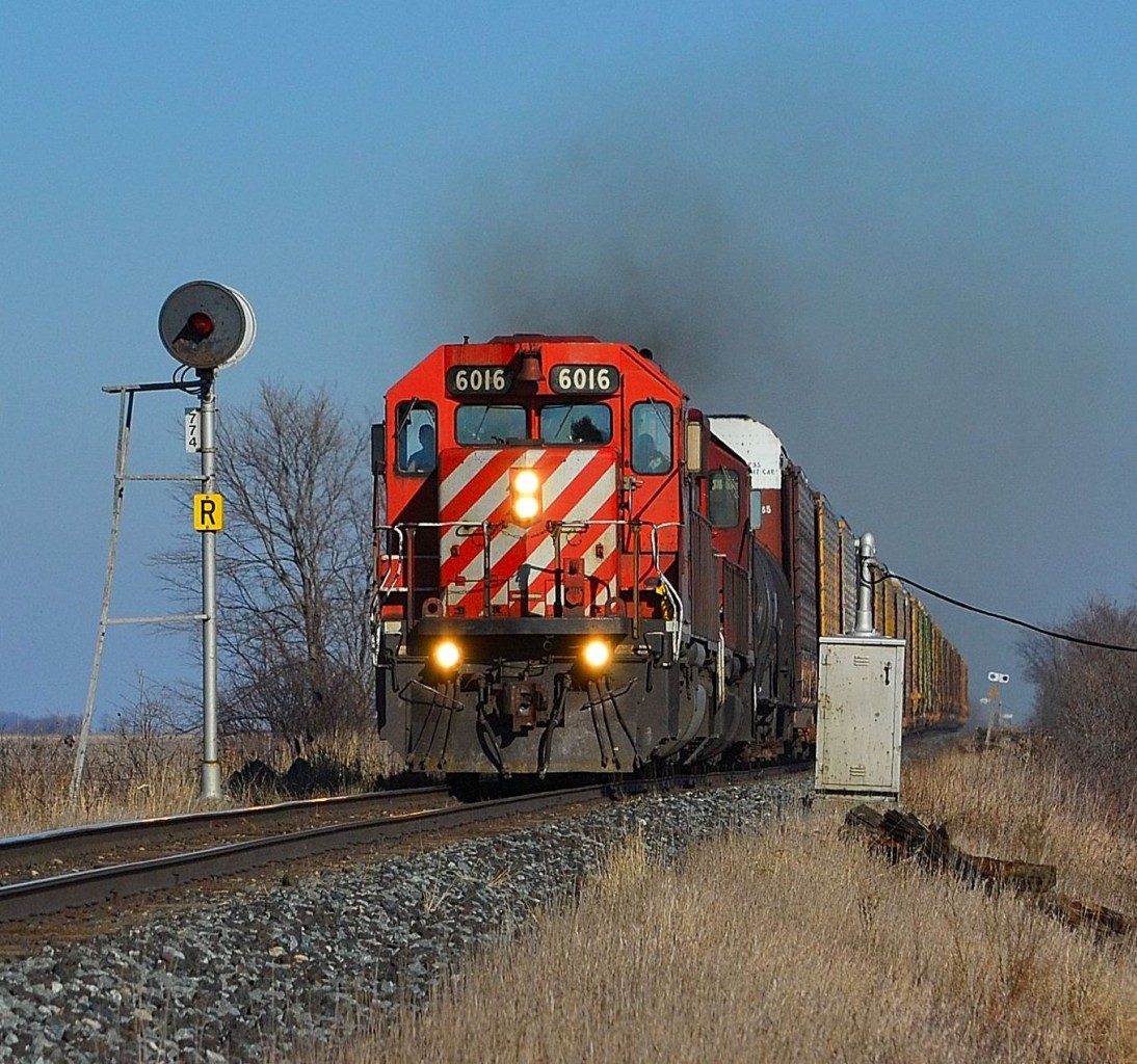 CP 249 led by a pair of SD40-2s, chugs along westbound towards Windsor as it passes the signal at mile 77.4