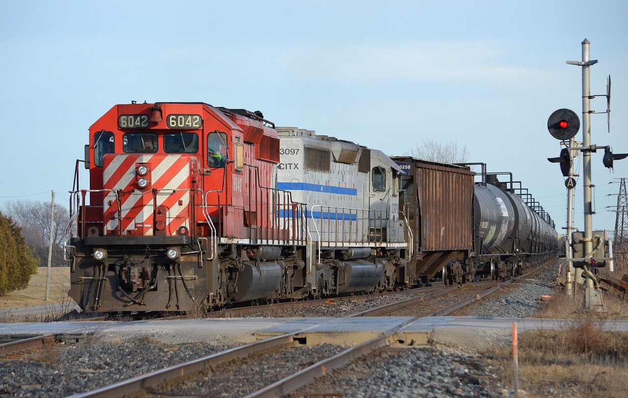 CP 6042 and CITX 3097 proceed to haul this westbound ethanol train into the siding at Tilbury to allow an oncoming eastbound train to pass by.