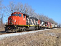 CN 439 led by a GP38-2W and a GP9RM, hauls this short mixed freight train westbound thru Jeannettes creek on its way towards Windsor.